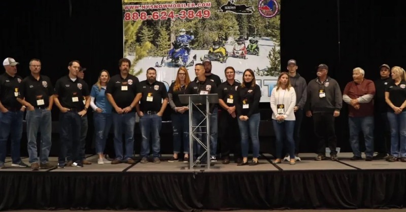 A group of people standing in front of a microphone.