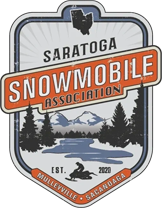 A badge with trees and mountains in the background.